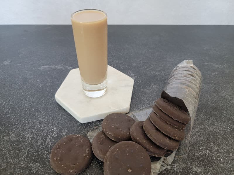 Cocktail shot on a white coaster next to a package of Thin Mint Cookies