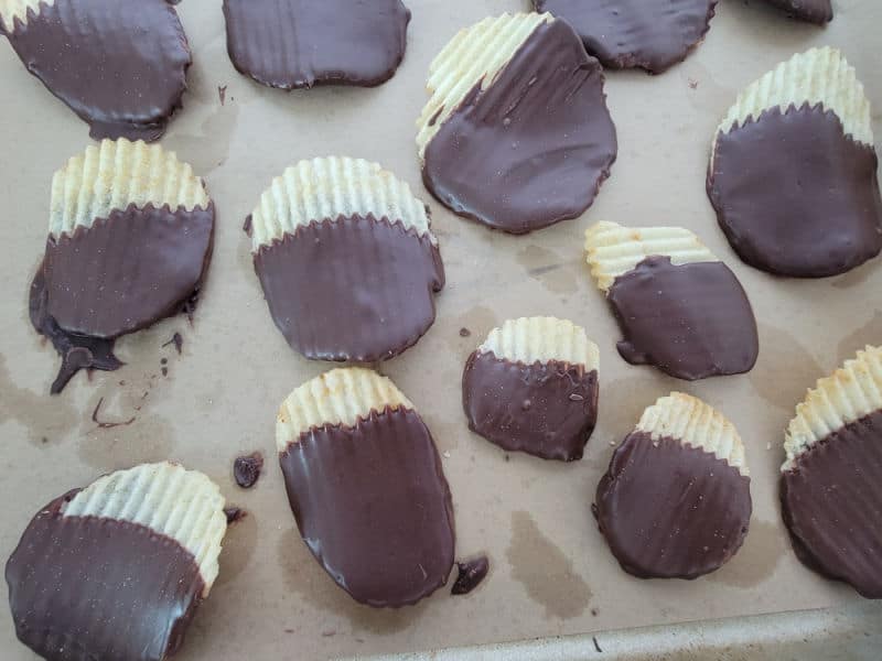 Chocolate dipped Ruffles potato chips on parchment paper