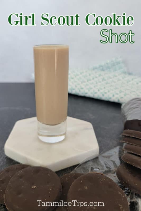 Girl Scout Shot text above a filled shot glass on a white coaster surrounded by thin mint cookies