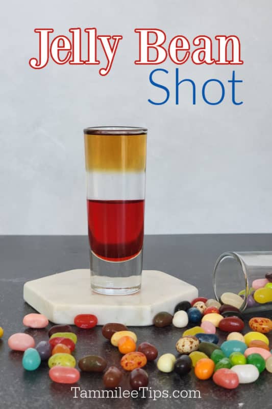 Jelly Bean Shot text over a layered shot sitting on a white coaster surrounded by jelly beans