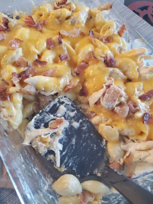 Chicken Bacon Ranch Casserole topped with shredded cheese in a baking dish