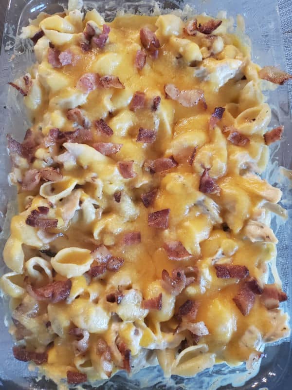 chicken bacon ranch casserole covered in melted cheese in a casserole dish