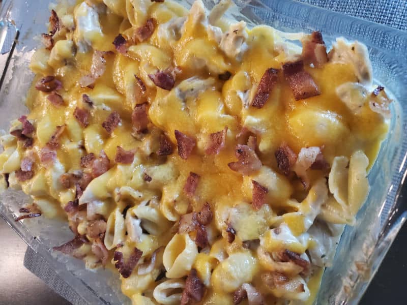 Chicken Bacon Ranch Casserole topped with shredded cheese in a baking dish