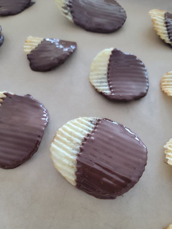 Ruffles Potato Chips dipped in chocolate on parchment paper