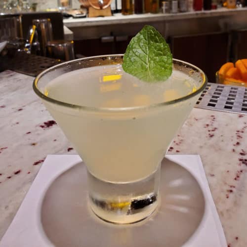 Alchemy Bar Revved Up Mojito Martini on a white napkin with mint leave garnish