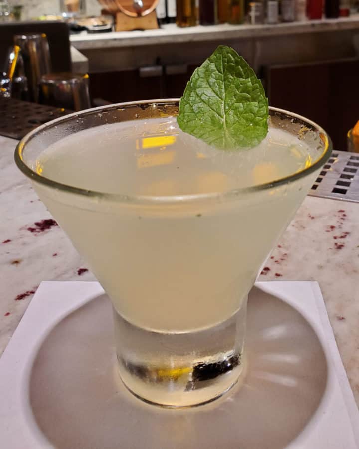 Alchemy Bar Revved Up Mojito Martini on a white napkin with mint leave garnish