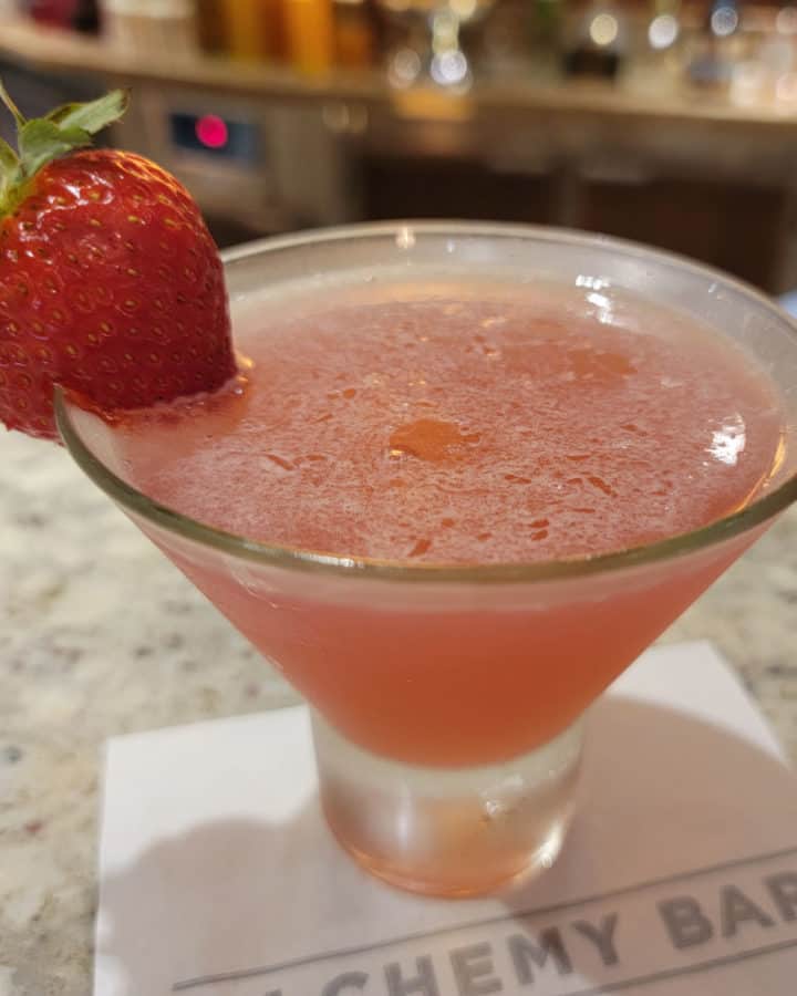 Alchemy Bar Curative Peach Cosmopolitan cocktail on a white napkin