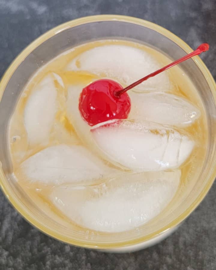 Fireball ginger ale cocktail with maraschino cherry garnish