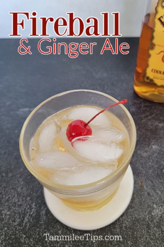 Fireball & Ginger Ale above a cocktail garnished with a cherry . partial fireball whiskey bottle in the background