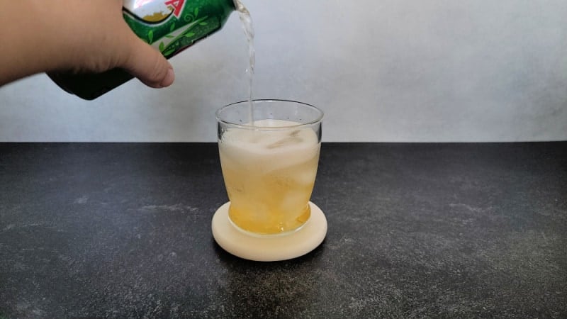Ginger Ale pouring into a cocktail glass