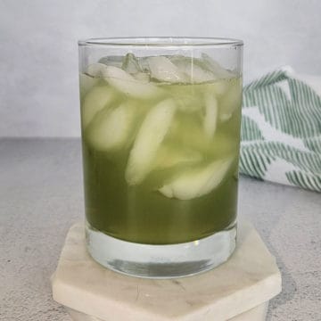 Incredible Hulk Drink in a cocktail glass on a white coaster