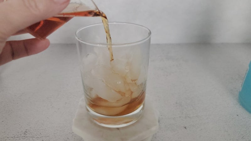 Hennessey Cognac pouring into a cocktail glass