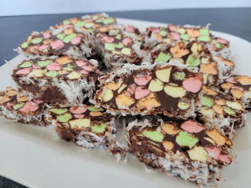 sliced no bake church window cookies coated in coconut on a white platter