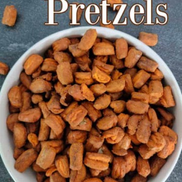 Buffalo Pretzels text over a white bowl filled with buffalo hot sauce flavored pretzel nuggets