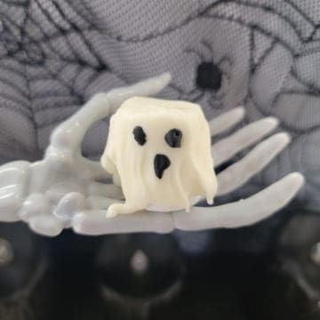 Marshmallow Ghost sitting on a skeleton hand
