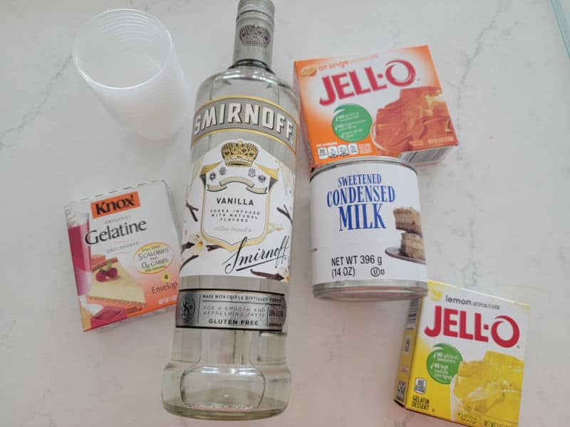 Candy Corn Jello shots ingredients, gelatin, vanilla vodka, sweetened condensed milk, orange jello, and lemon jello