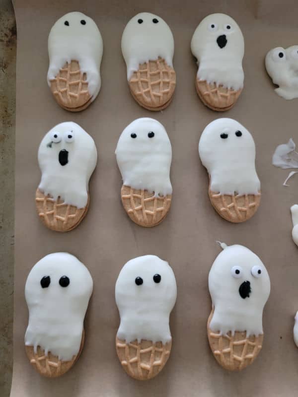 Nutter Butter Ghosts on parchment paper with different faces