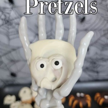 ghost pretzel held in a skeleton hand with ghost pretzels text above