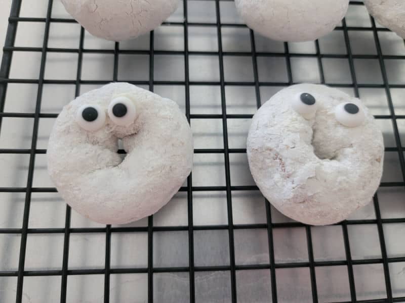 Powdered sugar donuts with candy eyes