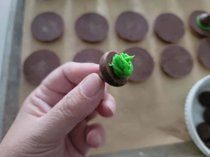green icing on a hershey kiss for witch hat cookies