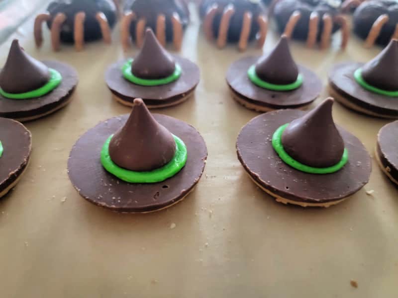 green rimmed witch hat cookies on parchment paper