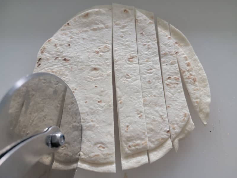 pizza cutter cutting tortillas 