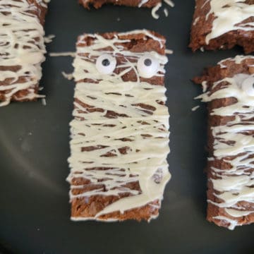 Mummy Brownies on a black plate