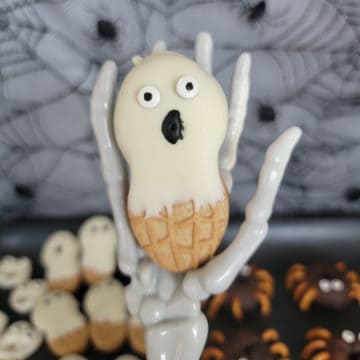 Nutter Butter Ghost held by a skeleton hand