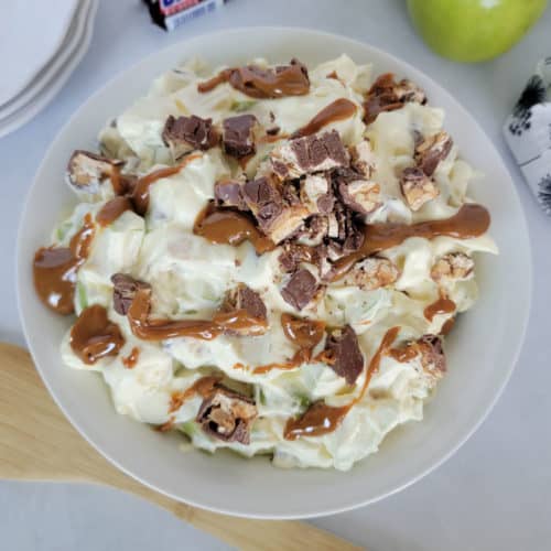 Apple and Snickers Salad in a white bowl