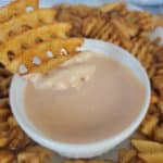 waffle fry dipping into a bowl of Comeback Sauce