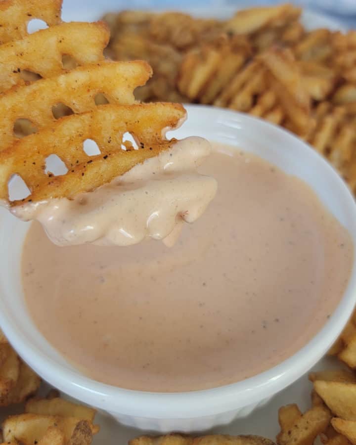 waffle fry dipping into a bowl of Comeback Sauce