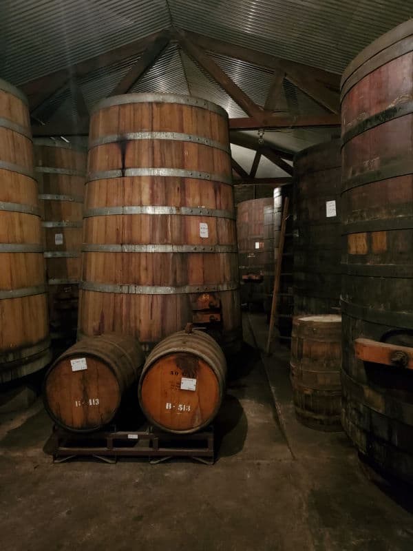 large wine barrels inside Ficklin Vineyards historic cellar