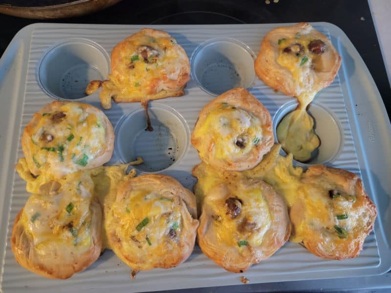 Sausage Breakfast Biscuit Cups in a blue muffin pan after being baked in the oven. 