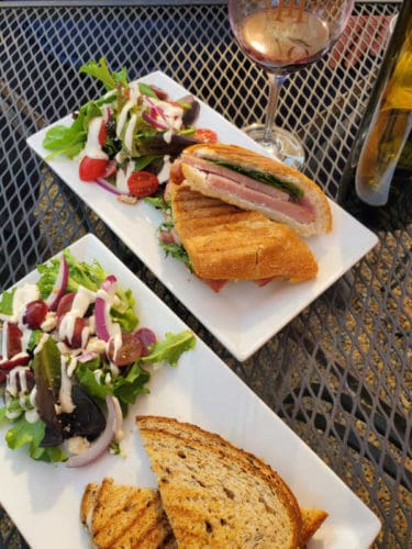 Sandwiches and salads on white plates at Idle Hour Winery Oakhurst
