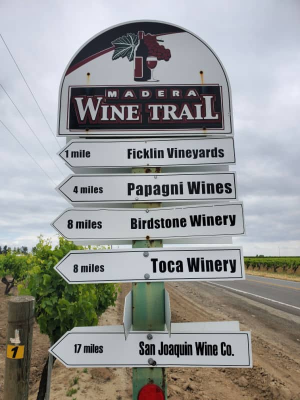 Madera Wine Trail sign with miles to multiple vineyards