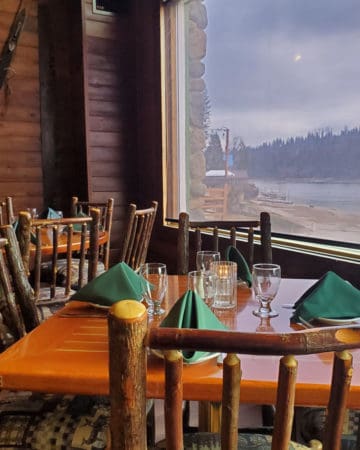 wooden tables overlooking Bass Lake at Ducey's on the Lake in California