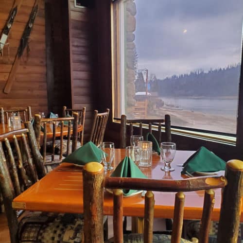 wooden tables overlooking Bass Lake at Ducey's on the Lake in California