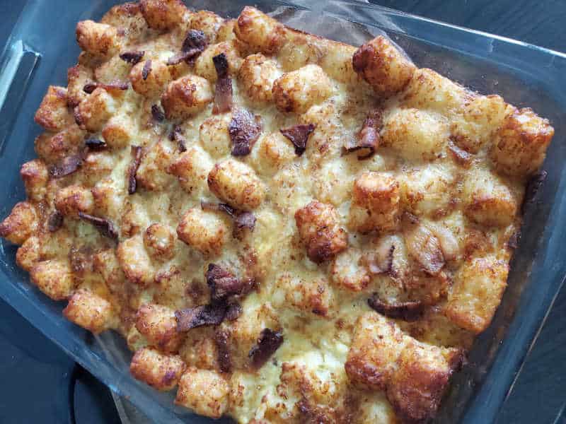 baked tater tot breakfast casserole with bacon in a casserole dish