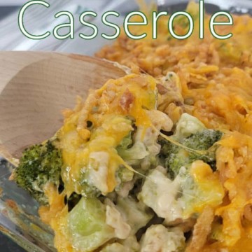 Broccoli Casserole text printed over a wooden spoon scooping cheesy broccoli casserole out of a glass dish.