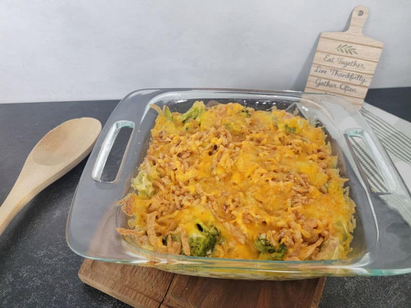 Cheesy Broccoli Casserole Recipe next to a wooden spoon