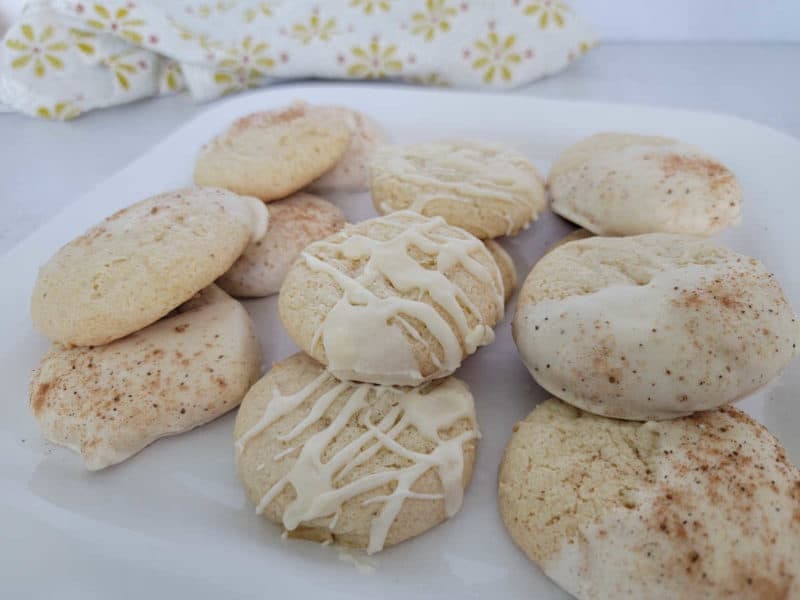 eggnog cookies on a white plate with a cloth napkin