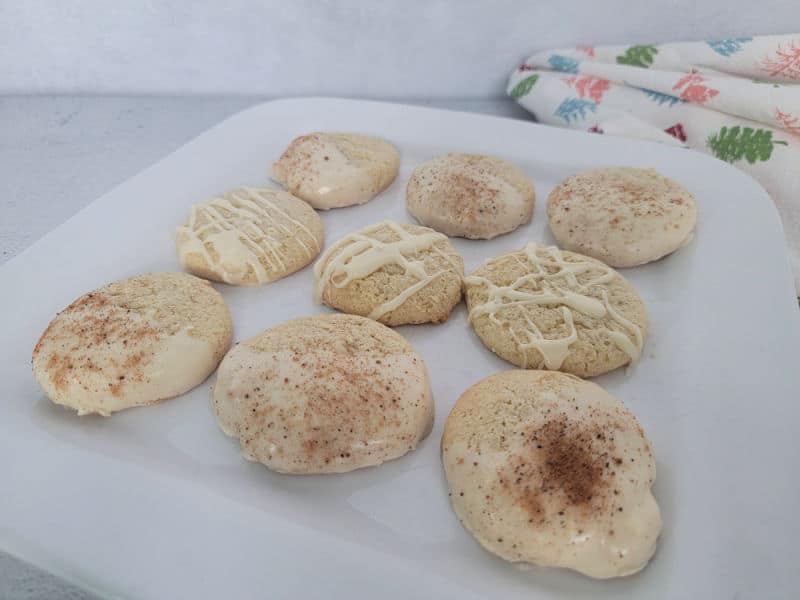 Eggnog cookies with eggnog glaze on a white plate