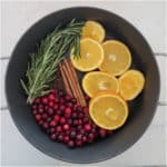 pot filled with Christmas potpourri cranberries, orange slices, cinnamon, cloves and more