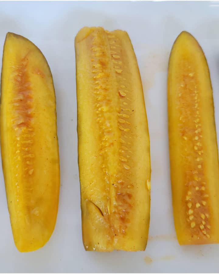 Taco pickle spears on a white platter