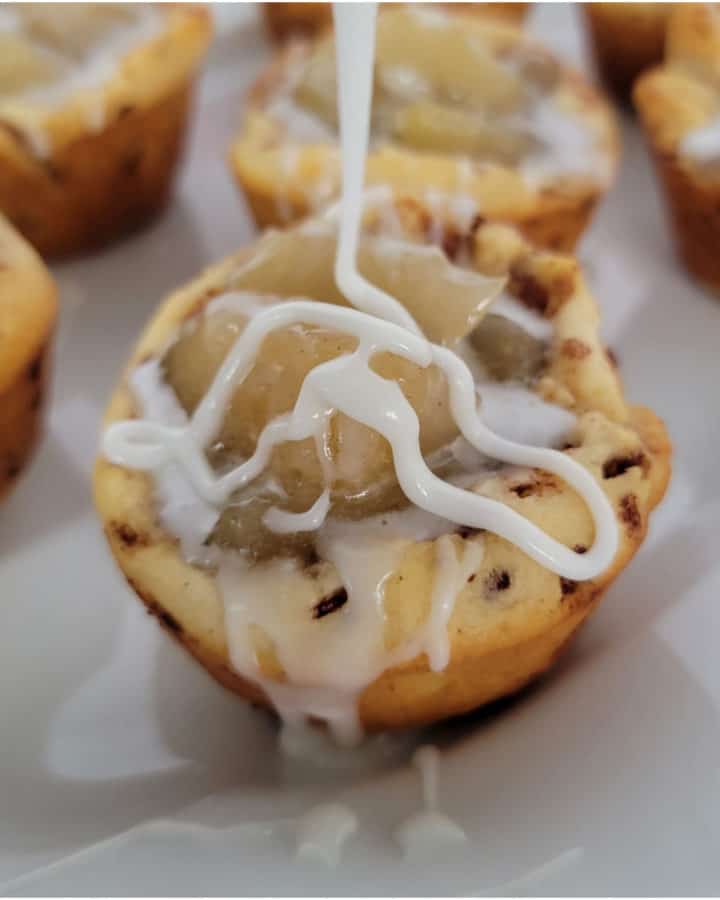 Icing drizzling onto a 2 Ingredient Cinnamon Roll Apple Pie Cups