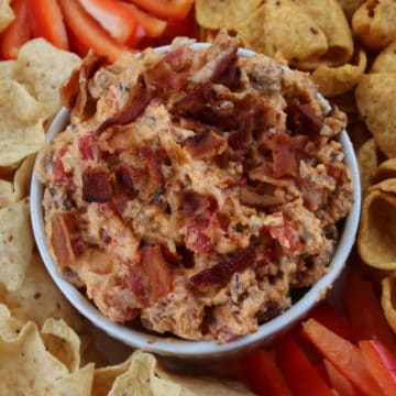 Bacon cheeseburger dip surrounded by pepper strips and tortilla chips