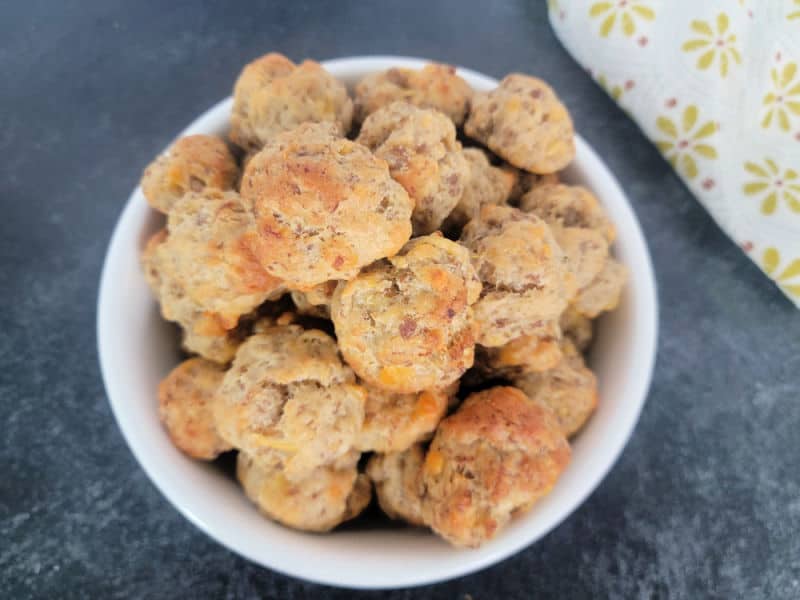 Cheddar Bay Sausage Balls in a white bowl with a cloth napkin