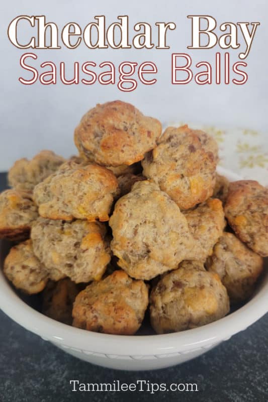 Cheddar Bay Sausage Balls text over a white bowl filled with sausage balls