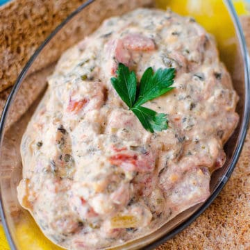 Crock Pot Mexican Spinach Dip in a glass dish with crackers