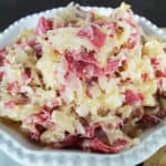 reuben dip with corned beef in a white bowl